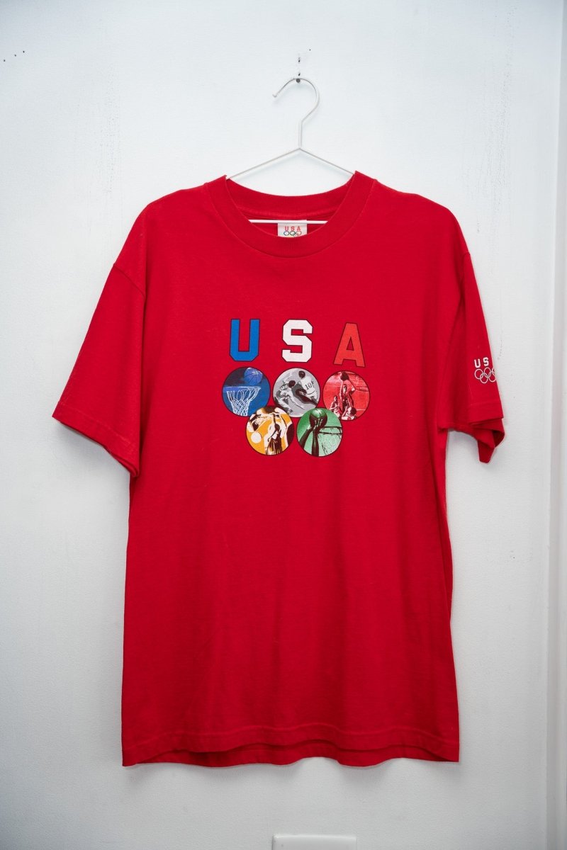 Red 90s USA Olympics tee red white blue USA letters five Olympic sport photo circles rings formation US Olympics sleeve logo