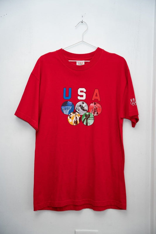 Red 90s USA Olympics tee red white blue USA letters five Olympic sport photo circles rings formation US Olympics sleeve logo