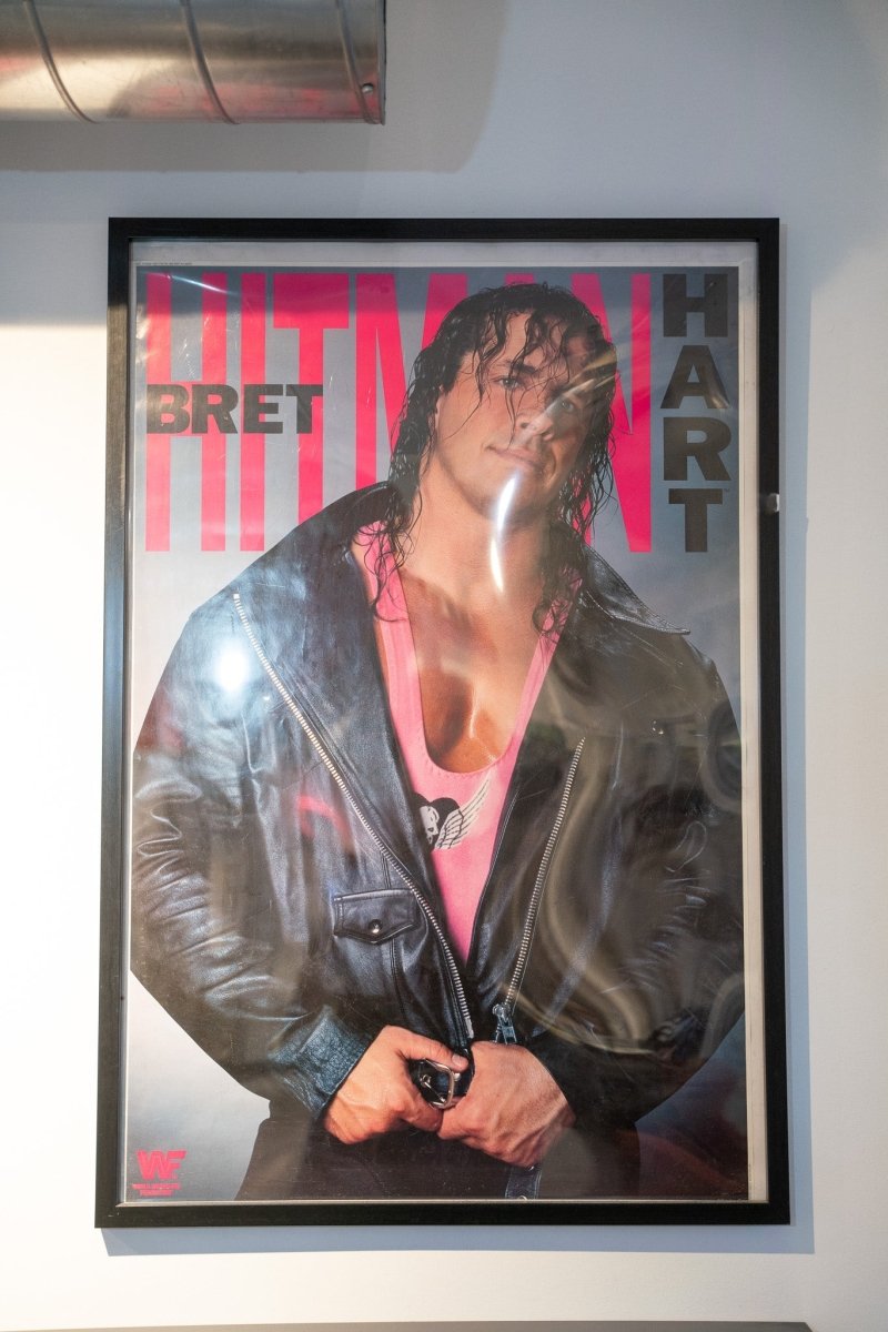 WWF Bret Hitman Hart poster framed long black hair leather jacket pink tank top BRET HITMAN HART red letters WWF logo Titan Sports