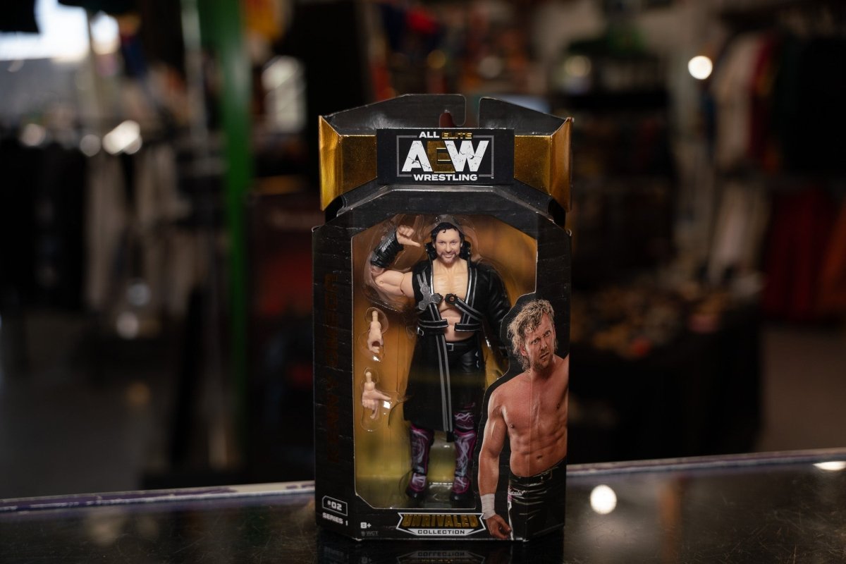 AEW Unrivaled Collection action figure in black and white wrestling attire with blonde hair, displayed against neutral background