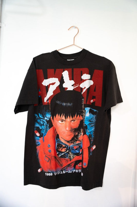 Black Akira 1988 tee with red AKIRA text white Japanese katakana Kaneda portrait red jacket goggles blue characters capsule pills size Large