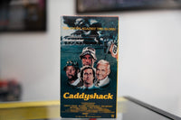 Caddyshack VHS green-toned sleeve with Chevy Chase Bill Murray Rodney Dangerfield Ted Knight golf course gopher yellow Caddyshack script Snobs Against Slobs tagline