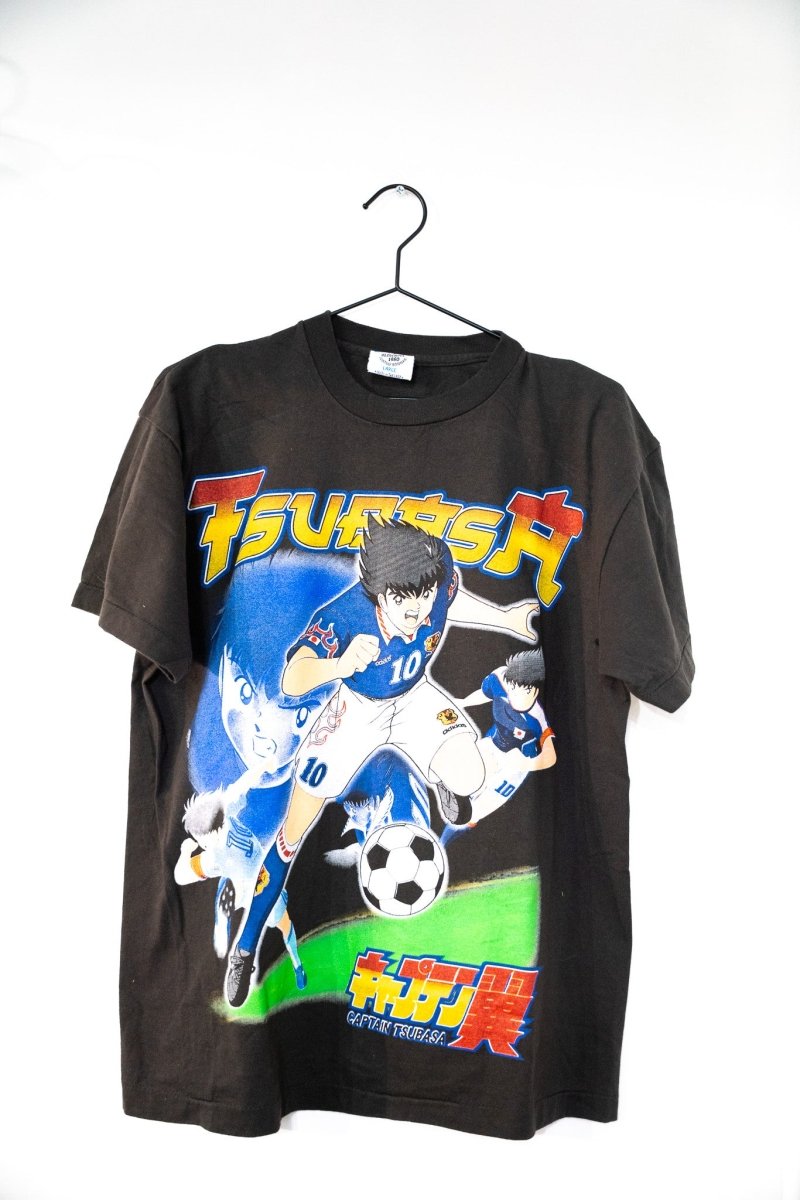 Black Captain Tsubasa t-shirt with bold TSUBASA lettering anime Tsubasa Ozora in white 10 Japan jersey kicking soccer ball Japanese text size Large