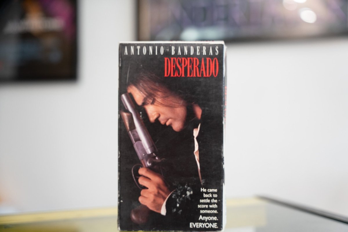 Desperado VHS dark sleeve with Antonio Banderas clutching shotgun in moody close-up red DESPERADO title and Anyone Everyone tagline
