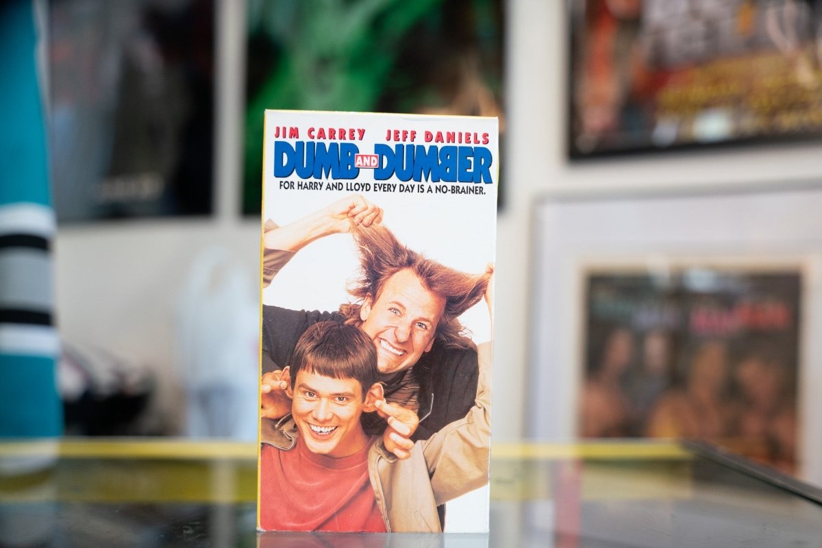 New Line Cinema Dumb and Dumber VHS tape from 1994, showing the movie's cover artwork with bright colors and the film's title text displayed on the spine and front
