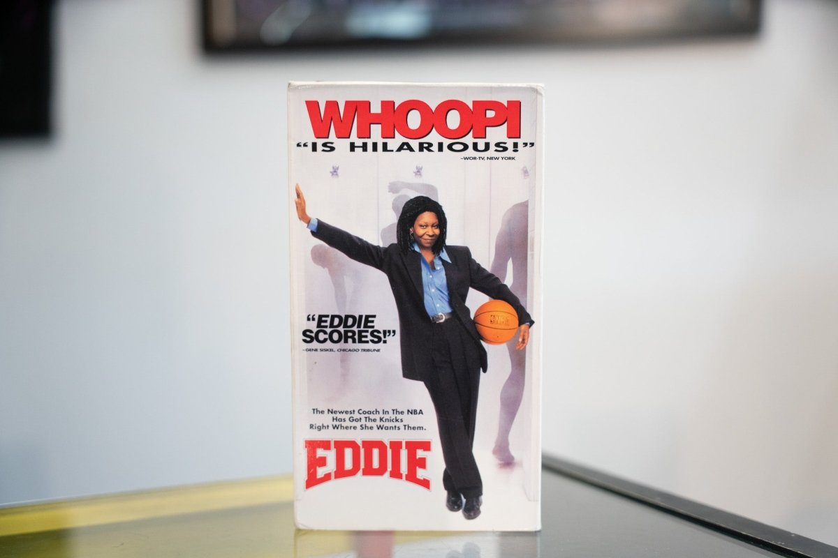 Eddie VHS white sleeve with large red WHOOPI text Whoopi Goldberg in black suit holding basketball Knicks coaching tagline red EDDIE title
