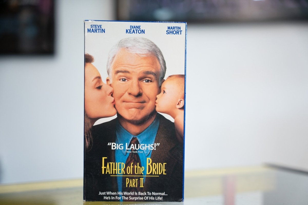Father of the Bride Part II VHS with Steve Martin daughter kissing cheek baby on other side blue shirt Big Laughs quote and elegant title