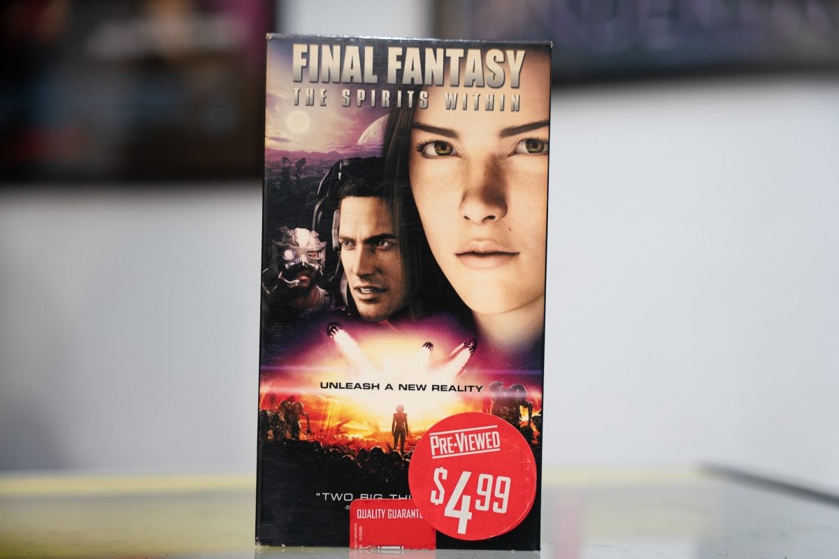 Final Fantasy The Spirits Within VHS dark sleeve with photorealistic CG close-ups of Aki Ross and Captain Gray Edwards silver title lettering