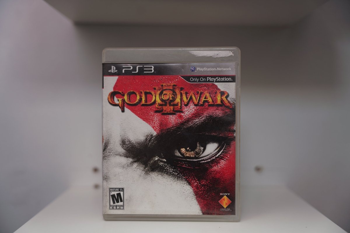 PlayStation 3 God of War III PS3 case extreme close-up Kratos white skin red war paint golden eye GOD OF WAR III gold red text Sony Mature