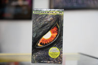 Sealed Godzilla 1998 VHS with massive close-up of Godzilla eye fiery orange iris green metallic title SIZE DOES MATTER tagline and flashlight offer sticker