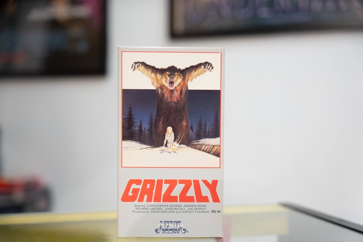 Grizzly VHS white sleeve red border with painted giant grizzly bear roaring over camper in snow red GRIZZLY title Media Home Entertainment