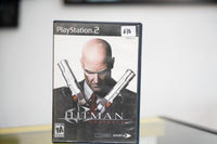 Hitman Contracts PlayStation 2 black case with Agent 47 in suit and red tie holding two crossed silver Silverballer pistols and silver title text