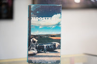 Hoosiers VHS with blue Indiana sky worn black Converse sneakers on wood white HOOSIERS title Gene Hackman Barbara Hershey Dennis Hopper Hemdale