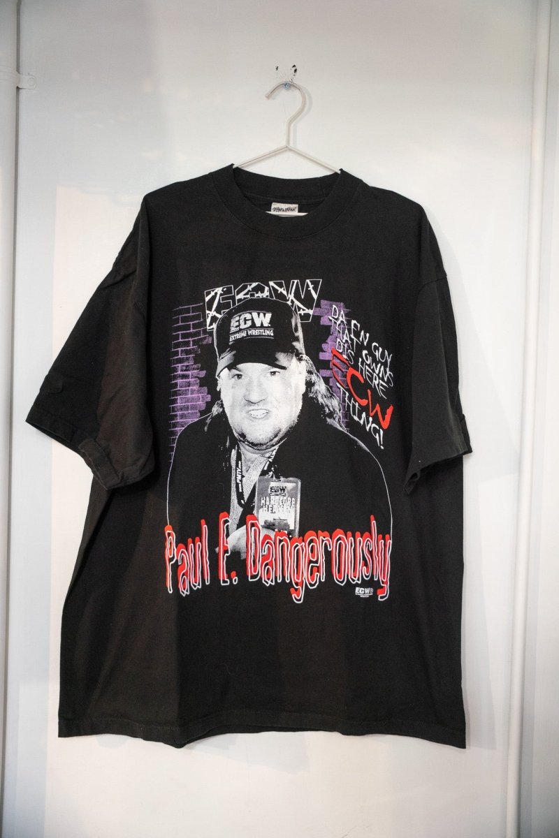 Black ECW Paul E Dangerously t-shirt with black and white Paul Heyman photo in ECW cap purple brick wall background and red script lettering size XXL