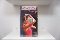 Kathy Smith's Tone Up VHS cover with Smith in pink leotard stretching resistance band, sealed in shrink wrap with barcode sticker