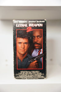 Lethal Weapon 2 VHS cover with Mel Gibson and Danny Glover in red-bordered photo, Glover holding gun, white title text with red 2