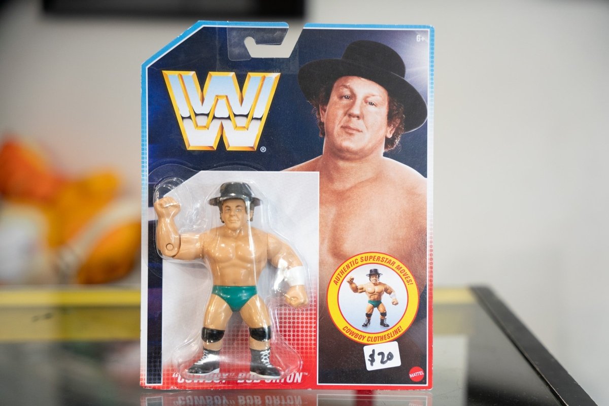 Mattel WWE Retro Cowboy Bob Orton action figure retro packaging black cowboy hat green trunks Cowboy Clothesline move badge WWF logo