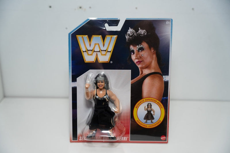 Mattel WWE Retro Sensational Queen Sherri action figure retro packaging black dress tiara silver hair Sensational Suckerpunch move badge WWF logo