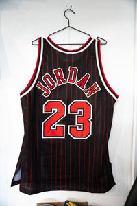 Champion Michael Jordan Chicago Bulls pinstripe stitched jersey size 48 from 1996-97 season, displayed flat against white background