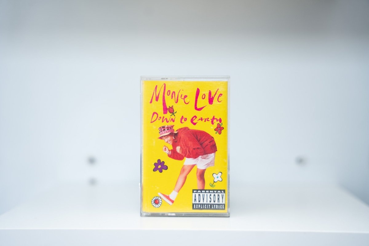 Monie Love Down to Earth cassette tape yellow background Monie in red jacket plaid hat flowers pink Monie Love text Parental Advisory