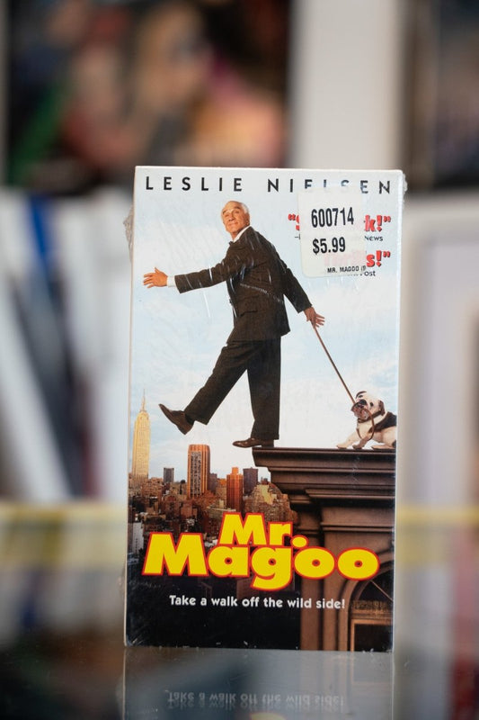 Mr Magoo VHS tape sealed in shrink wrap with Leslie Nielsen stepping off building ledge above New York City skyline