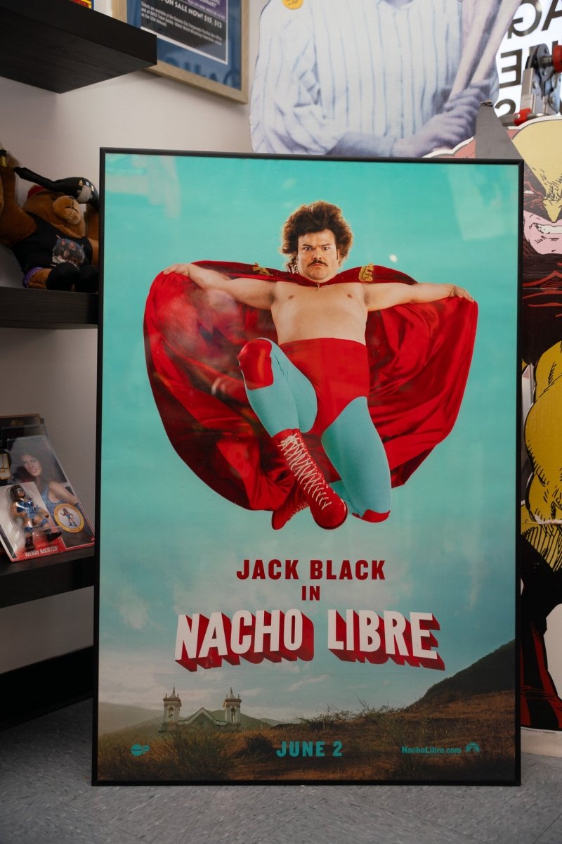 Framed Nacho Libre official 27x40 movie theater poster with Jack Black in red cape and wrestling boots leaping against turquoise sky