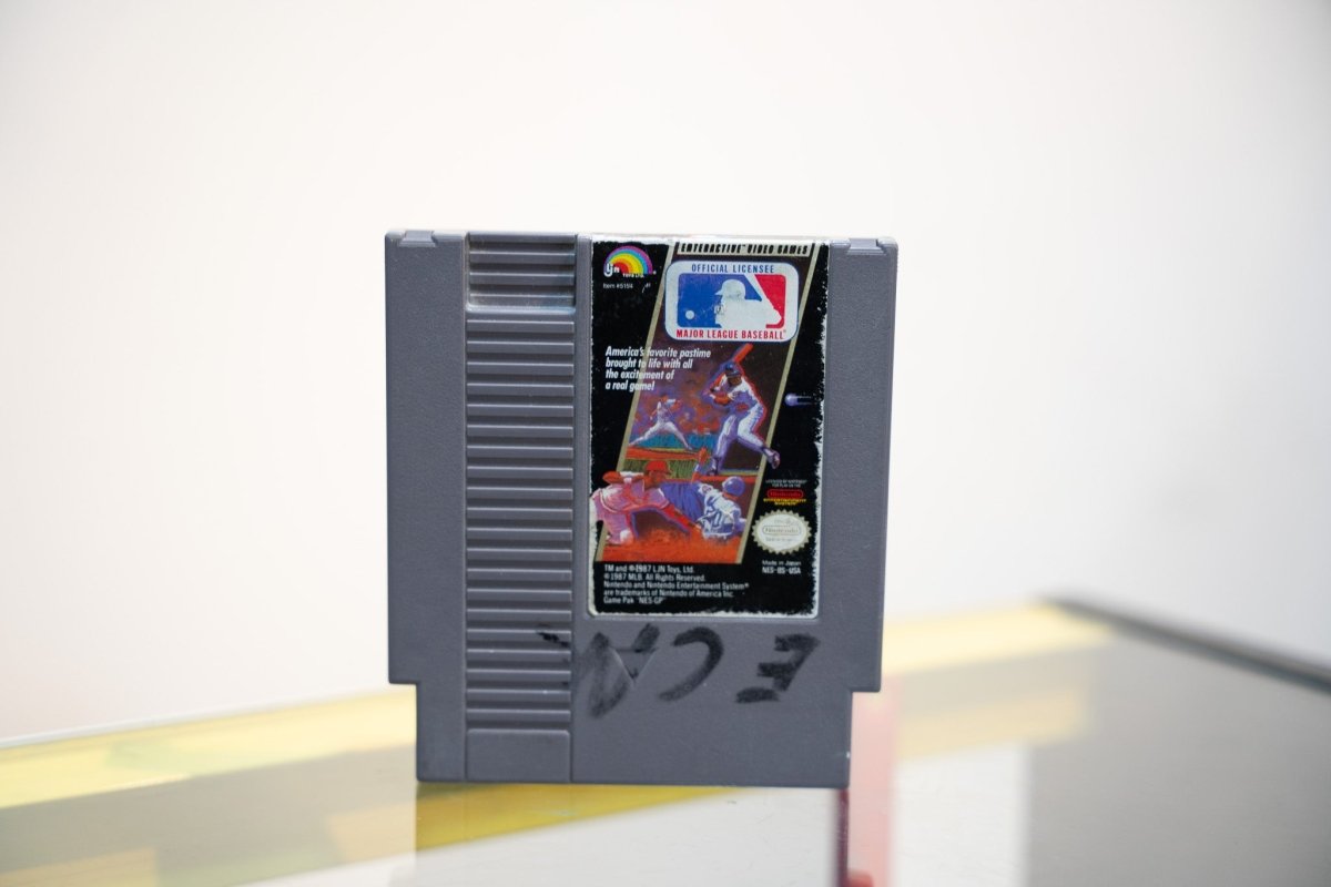 NES Major League Baseball grey cartridge with MLB logo and baseball action artwork, LJN rainbow logo, writing on cart