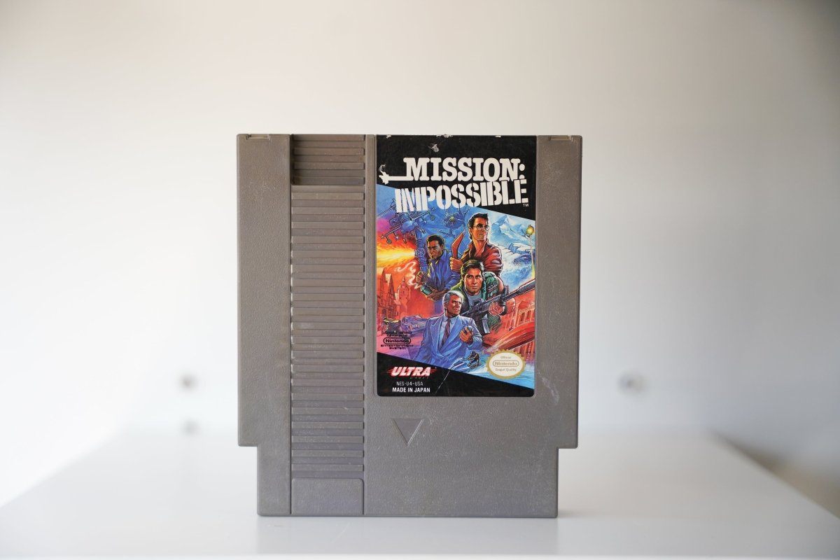 NES Mission Impossible gray cartridge three agents suits explosions helicopters MISSION IMPOSSIBLE white text ULTRA Konami Nintendo