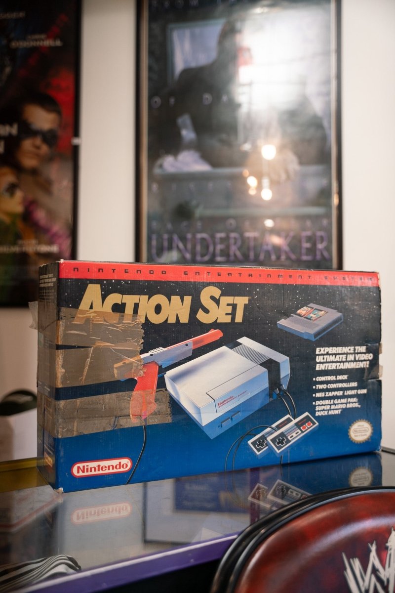 Nintendo NES Action Set complete in blue retail box with gold Action Set lettering showing console Zapper gun and controllers
