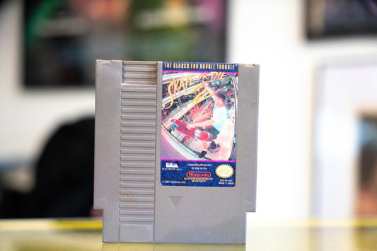 Nintendo NES Skate or Die 2 The Search for Double Trouble gray cartridge with fisheye skateboarding photo and yellow punk-style title lettering by Electronic Arts
