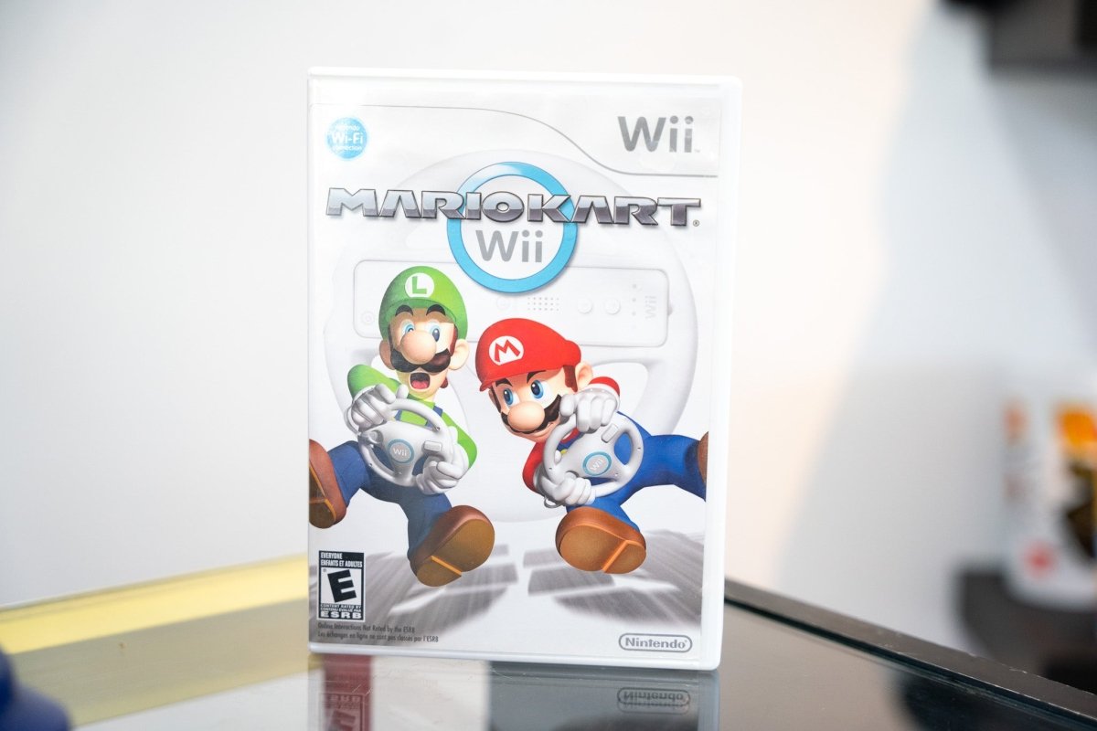 Nintendo Wii Mario Kart Wii game case Mario Luigi holding Wii Wheels racing cover art white case ESRB Everyone