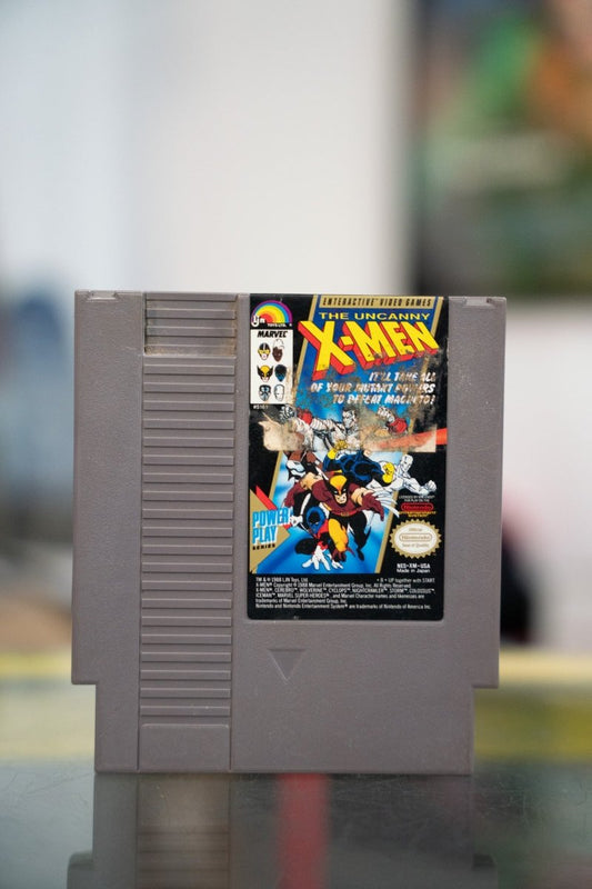 Nintendo NES The Uncanny X-Men gray cartridge with comic-book art of Wolverine Colossus Iceman and X-Men team with yellow title lettering