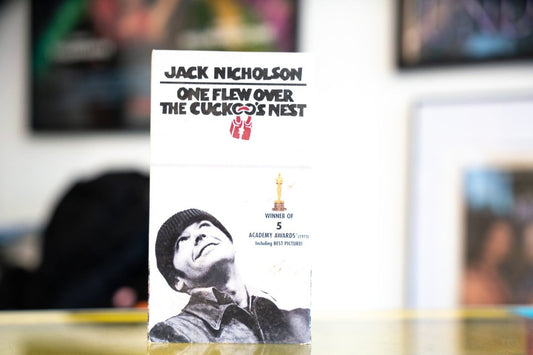 One Flew Over the Cuckoo's Nest white VHS clamshell case with Jack Nicholson black and white photo in knit cap and gold Academy Award winner of 5 Oscars text