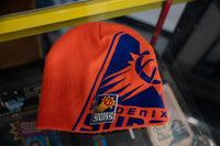 Orange Phoenix Suns knit beanie with large navy blue sunburst logo wrapping around hat and embroidered Suns basketball patch