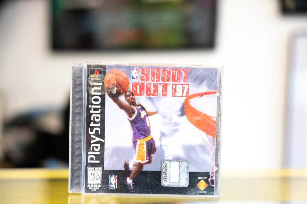 PlayStation NBA ShootOut 97 jewel case with Lakers player dunking basketball red and white SHOOT OUT 97 title and NBA logo