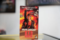 Red Scorpion VHS fiery orange red sleeve with Dolph Lundgren in military gear holding gun helicopters explosions and red metallic RED SCORPION title