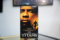 Remember the Titans VHS amber sleeve with Denzel Washington close-up silhouetted football player golden glow Disney white REMEMBER THE TITANS title