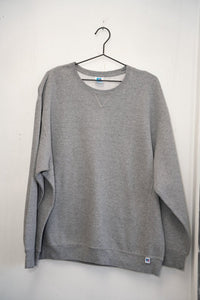 Heather gray Russell Athletic blank crewneck sweatshirt V-notch detail Russell R tag blue woven patch lower hem ribbed cuffs