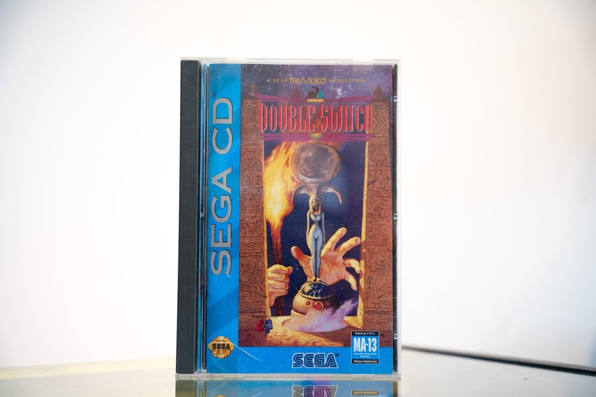 Sega CD Double Switch game complete in tall case blue spine Egyptian themed cover glowing orb flames carved pillars DOUBLE SWITCH purple gold text MA-13