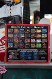 Sega Genesis console with Sonic 2 game, original box, controllers, and cables displayed together, 1992