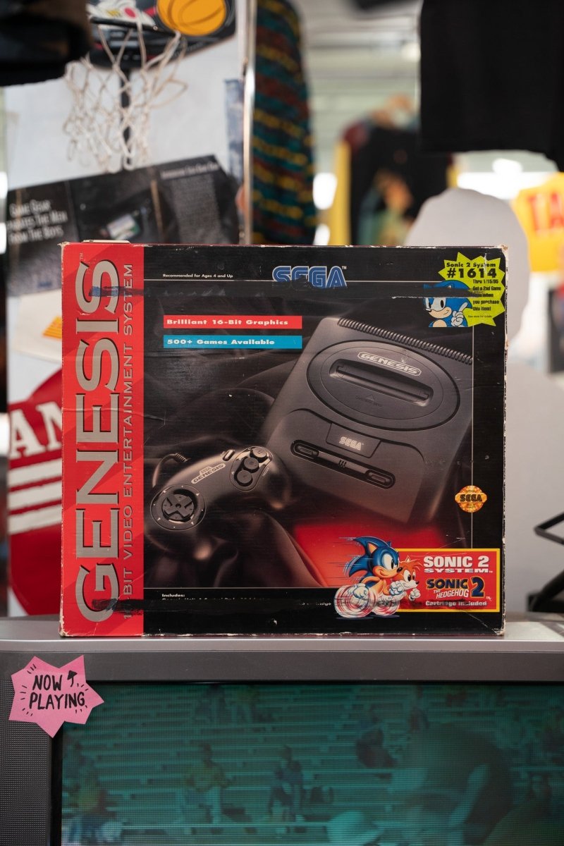 Sega Genesis Model 2 console complete in box with Sonic 2 cartridge bundle showing console and controller on retail box art