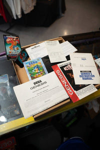 Sega Genesis console with controllers, cables, and Sonic 2 game cartridge displayed in original box, 1990s