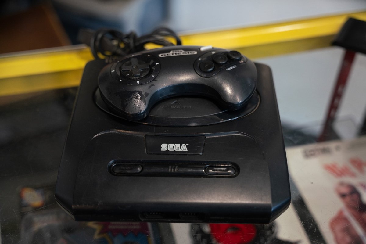 Black Sega Genesis Model 2 console with 6-button controller power cord top-loading cartridge slot and SEGA front logo
