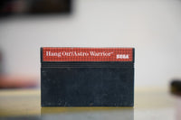 Sega Master System Hang-On Astro Warrior black cartridge with red label strip white title text and Sega logo