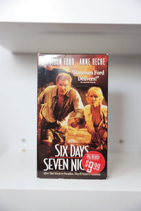 Six Days Seven Nights VHS cover with Harrison Ford and Anne Heche running through jungle with explosions, Pre-Viewed sticker