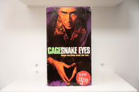 VHS Snake Eyes Nicolas Cage intense stare patterned shirt triangle hands gold bracelet CAGE green SNAKE EYES yellow text believe eyes tagline Pre-Viewed