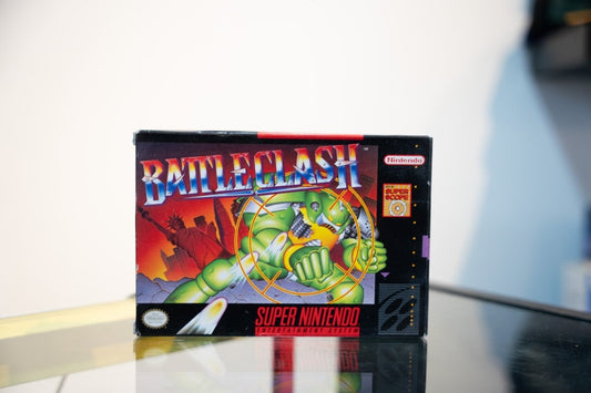 SNES BattleClash box with green mech robot in targeting crosshair, Statue of Liberty background, Super Scope badge, Nintendo logo