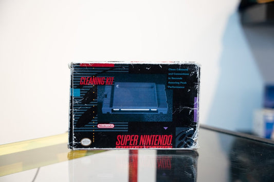 SNES Cleaning Kit box with Super Nintendo console photo, Clean Contacts and Connections text, Nintendo logo, dark design with red accents