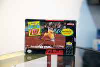 SNES David Crane's Amazing Tennis box with tennis player on clay court, Nintendo Power quote, Foot Locker coupon sticker, Absolute Entertainment