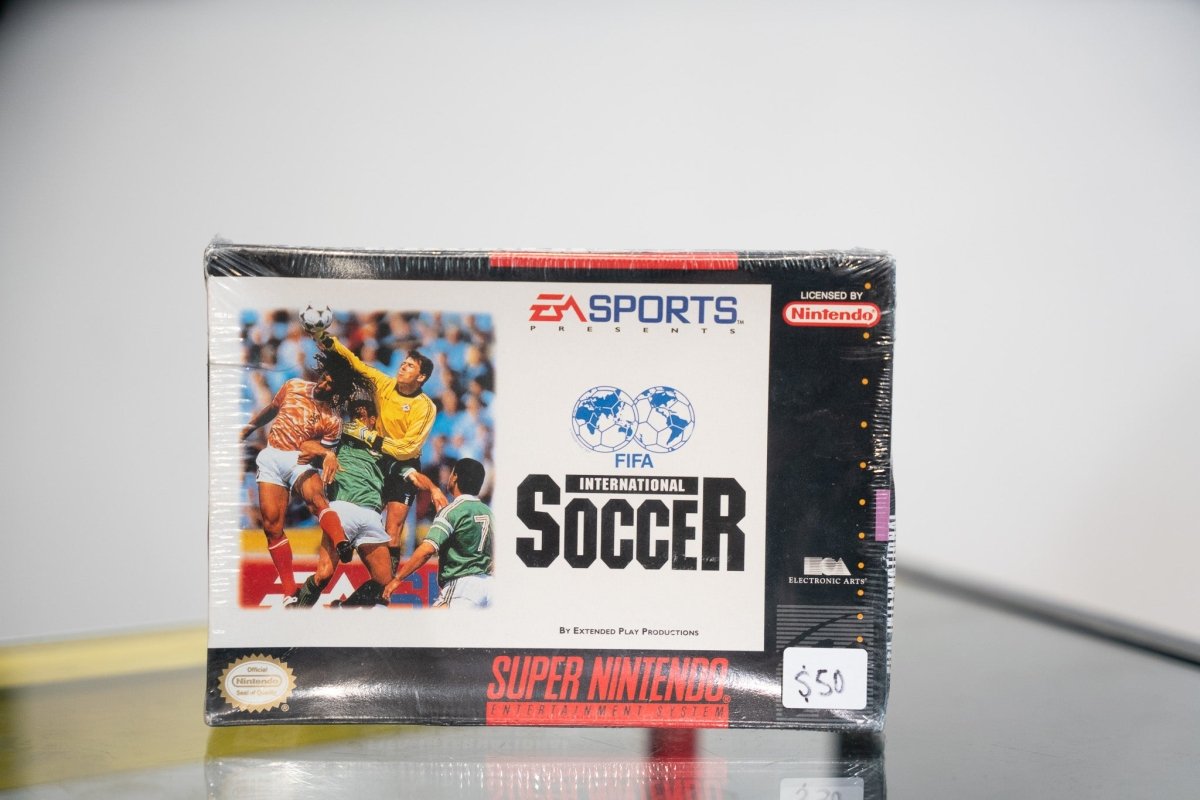 SNES FIFA International Soccer box with soccer players competing, FIFA logo, EA Sports, appears sealed in shrink wrap with $50 sticker
